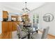 Dining area featuring a glass table, modern light fixture, and open layout connecting to the kitchen at 516 14Th Ne Ave, St Petersburg, FL 33701