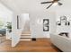 Bright living room with hardwood floors, fireplace, and staircase with wooden steps at 516 14Th Ne Ave, St Petersburg, FL 33701