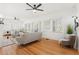 Spacious living room boasts natural light from many windows, showcasing the beautiful hardwood floors at 516 14Th Ne Ave, St Petersburg, FL 33701