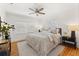 Light and airy main bedroom with a ceiling fan, refinished hardwood floor, and bright windows at 516 14Th Ne Ave, St Petersburg, FL 33701