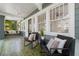 Inviting porch with swing, seating, tile flooring, and paneled door at 516 14Th Ne Ave, St Petersburg, FL 33701