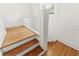 Staircase with refinished wood treads, white risers, and white railing at 516 14Th Ne Ave, St Petersburg, FL 33701