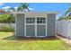 Close up of backyard storage building with white trim and gray siding at 516 14Th Ne Ave, St Petersburg, FL 33701