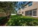 Lush backyard with mature trees, hedges, and ample green space at 5225 5Th N Way, St Petersburg, FL 33703