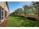 Well-maintained backyard with lush green grass, manicured landscaping, and a privacy fence at 5225 5Th N Way, St Petersburg, FL 33703