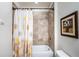 Bathroom with tile flooring and a shower-tub combination behind a decorative curtain at 5225 5Th N Way, St Petersburg, FL 33703
