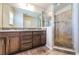 Modern bathroom with granite counters, dual sinks, and glass-enclosed shower at 5225 5Th N Way, St Petersburg, FL 33703