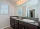 Elegant bathroom featuring dual sinks, granite counters, and ample natural light at 5225 5Th N Way, St Petersburg, FL 33703