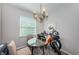 Bright dining area with a modern chandelier, round glass table, and a large window for natural light at 5225 5Th N Way, St Petersburg, FL 33703