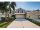 Charming townhome featuring a well-manicured lawn, stone accents, and a spacious two-car garage at 5225 5Th N Way, St Petersburg, FL 33703
