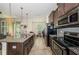 Open-concept kitchen featuring stainless steel appliances, a modern island, and nice lighting at 5225 5Th N Way, St Petersburg, FL 33703