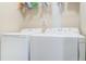 Bright laundry room with modern washer and dryer, with wire shelving at 5225 5Th N Way, St Petersburg, FL 33703