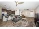 Open-concept living room with tile floors, ceiling fans, kitchen view and a comfortable gray sofa at 5225 5Th N Way, St Petersburg, FL 33703