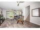 Bright living room with plush carpet, ceiling fan and sliding doors to the patio at 5225 5Th N Way, St Petersburg, FL 33703