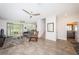 Open-concept living area with tile floors, ceiling fans, and access to a screened patio at 5225 5Th N Way, St Petersburg, FL 33703