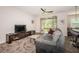 Comfortable living room with patio access, ceiling fan, and plush carpeting at 5225 5Th N Way, St Petersburg, FL 33703