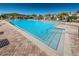 A refreshing community pool featuring clear blue water, brick pavers, and accessible entry steps at 5225 5Th N Way, St Petersburg, FL 33703