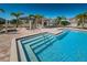 Community pool with clear blue water, brick pavers, pergola, and palm trees in a desirable neighborhood at 5225 5Th N Way, St Petersburg, FL 33703