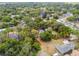 Aerial view of property with tree coverage, showing the house's lot outlined in red at 5232 72Nd N Way, St Petersburg, FL 33709