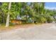 Street view of the home, showing its exterior surrounded by trees and foliage at 5232 72Nd N Way, St Petersburg, FL 33709