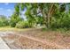 Shot of the lot with a view of the property framed by trees and foliage at 5232 72Nd N Way, St Petersburg, FL 33709