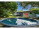 Backyard oasis with a refreshing stock tank pool and inviting outdoor living space, perfect for summer relaxation at 616 11Th Nw St, Largo, FL 33770