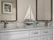 Close up on the double vanity, white cabinets, modern fixtures and decorative items at 616 11Th Nw St, Largo, FL 33770