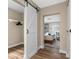 Bedroom area with a barn door leading to a closet and a view into the bedroom at 616 11Th Nw St, Largo, FL 33770