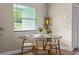 Cozy dining area with a round table, modern chairs, and natural light from a window at 616 11Th Nw St, Largo, FL 33770