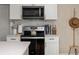 Modern kitchen boasts stainless steel appliances, white cabinetry, and stylish countertop decor at 616 11Th Nw St, Largo, FL 33770