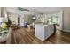 Open-concept living space with island kitchen, modern flooring, and seamless flow to the backyard patio at 616 11Th Nw St, Largo, FL 33770