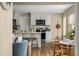 Well-lit kitchen adjacent to living room with quartz counters, stainless appliances, and beach decor at 616 11Th Nw St, Largo, FL 33770