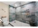 Modern tiled shower with glass door, updated fixtures, and white hexagon floor tiles at 616 11Th Nw St, Largo, FL 33770
