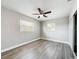 Bedroom featuring wood-look vinyl flooring, large windows, closet and fresh gray paint at 6269 50Th N Ave, St Petersburg, FL 33709