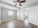 Bright bedroom with neutral paint, ceiling fan, a window that offers natural light, and modern floors at 6269 50Th N Ave, St Petersburg, FL 33709