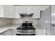Kitchen featuring stainless steel appliances, granite countertops and white cabinets at 6269 50Th N Ave, St Petersburg, FL 33709