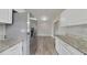 Modern kitchen featuring stainless steel appliances, granite countertops, and white cabinets at 6269 50Th N Ave, St Petersburg, FL 33709