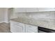 A close-up highlights the stunning granite countertops and modern cabinetry in the beautifully renovated kitchen at 6269 50Th N Ave, St Petersburg, FL 33709