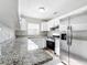 An updated kitchen features stainless steel appliances, stone countertops, and bright white cabinetry at 6269 50Th N Ave, St Petersburg, FL 33709