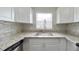 Kitchen featuring stainless steel appliances, granite countertops, backsplash and white cabinets at 6269 50Th N Ave, St Petersburg, FL 33709