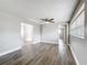 Living room with an open floor plan, ceiling fan and wood-look vinyl flooring at 6269 50Th N Ave, St Petersburg, FL 33709