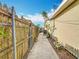 Side view of a narrow walkway to backyard with new AC, showcasing the home's exterior and access at 6269 50Th N Ave, St Petersburg, FL 33709