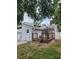 Exterior showcasing a wooden deck, sliding glass doors, and the home's siding under a canopy of trees at 6906 Shady Pl, Tampa, FL 33634