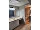 Bathroom featuring a vanity with ample countertop space and a separate toilet area at 6906 Shady Pl, Tampa, FL 33634