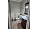 Cozy half-bathroom with a vanity and decorative mirror at 6906 Shady Pl, Tampa, FL 33634