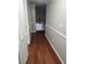 Hallway with hardwood floors, crown molding, and a view of the staircase at 6906 Shady Pl, Tampa, FL 33634