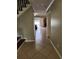 Hallway with tile flooring leading to the living room and pool area at 6906 Shady Pl, Tampa, FL 33634