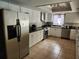 Modern kitchen with white cabinetry, dark counters, and stainless steel appliances at 6906 Shady Pl, Tampa, FL 33634