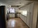 Well-lit kitchen with white cabinets, granite countertops, and stainless steel appliances at 6906 Shady Pl, Tampa, FL 33634