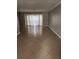 Bright living room featuring tile flooring, chandelier lighting, and a large window at 6906 Shady Pl, Tampa, FL 33634